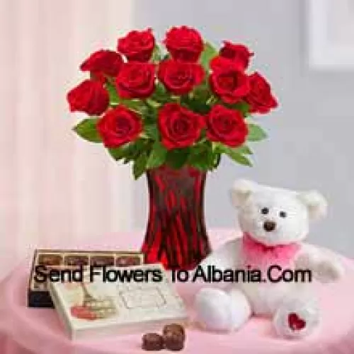 11 Rose Rosse con alcune felci in un vaso di vetro, un simpatico orsacchiotto bianco alto 12 pollici e una scatola di cioccolatini importati